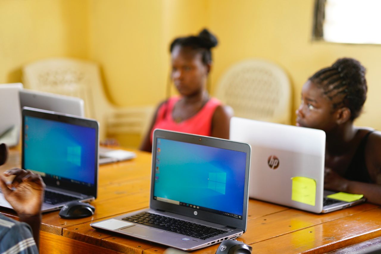 Students in a Haitian classroom working on laptops